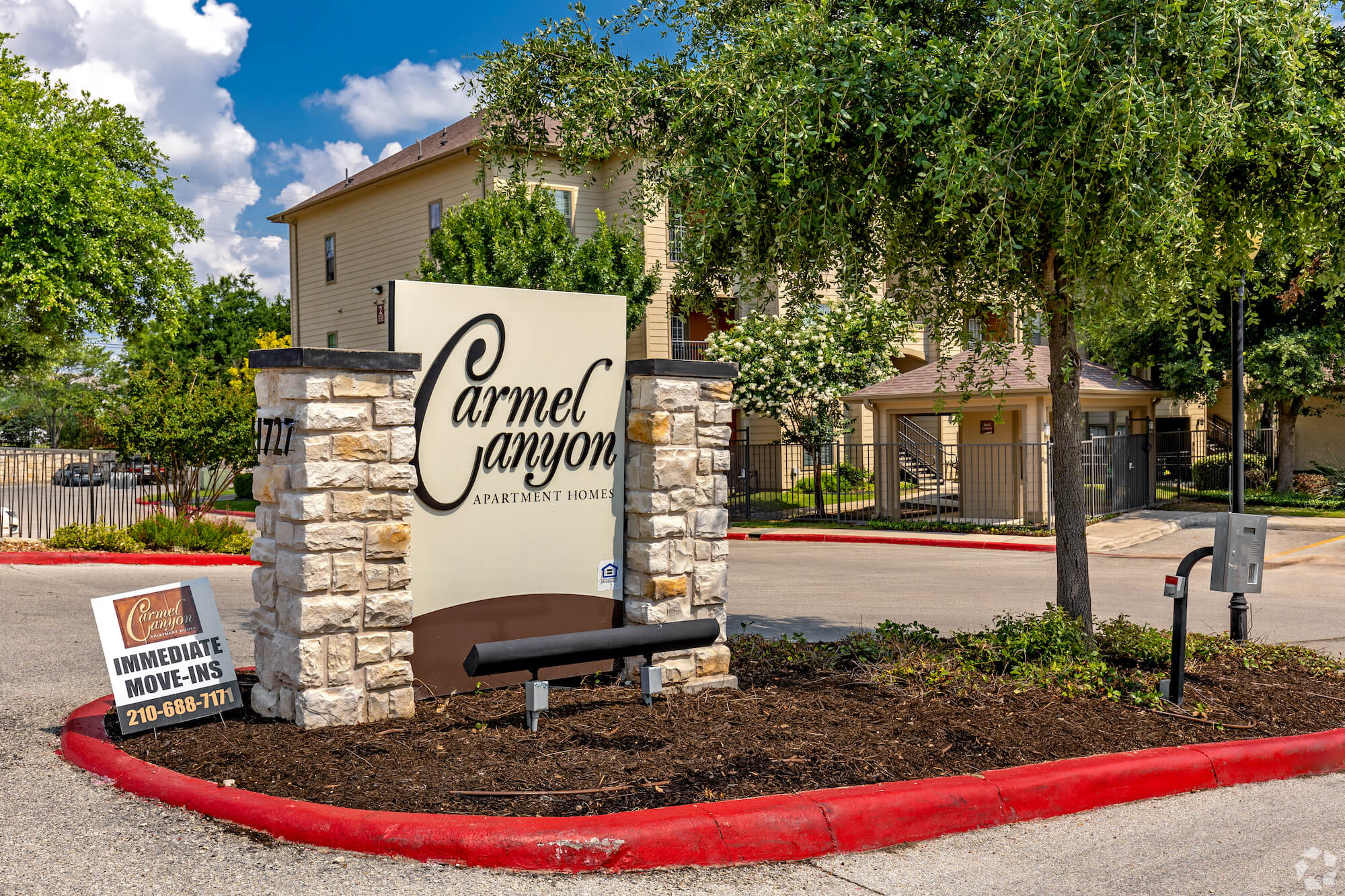 The entrance sign to Carmel Canyon Apartments.